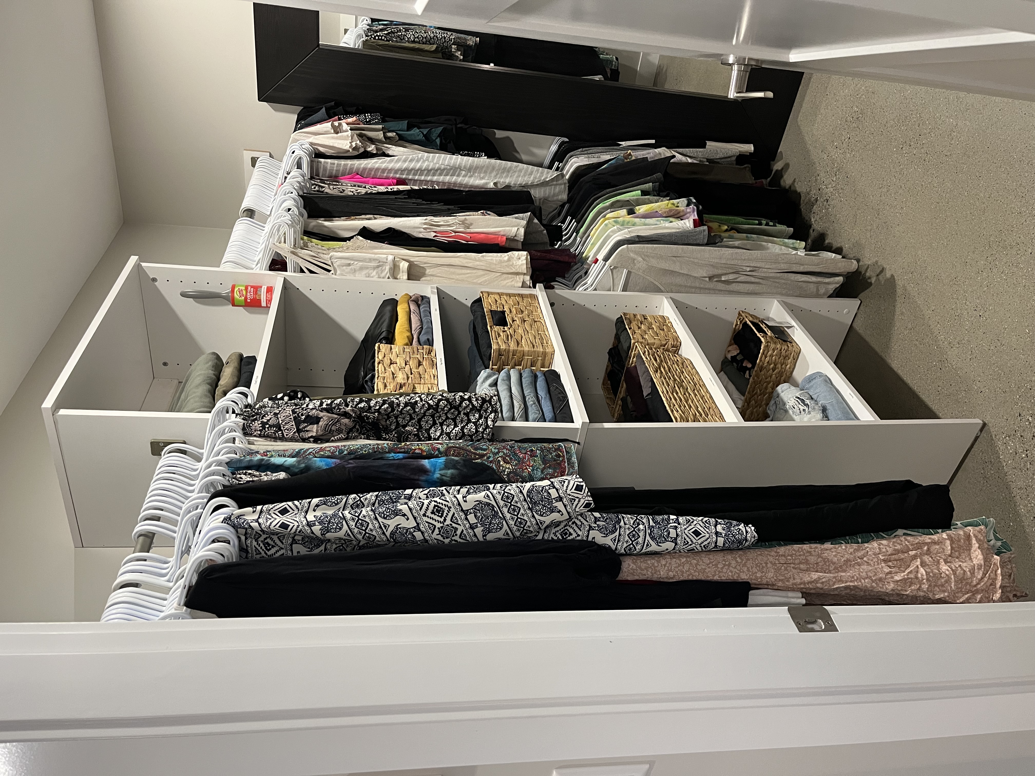 Organized closet with coordinated hangers and baskets